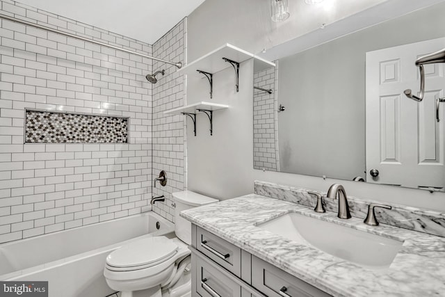 full bathroom featuring toilet, tiled shower / bath combo, and vanity