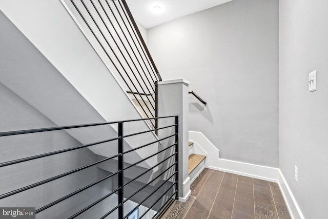 stairs featuring wood-type flooring