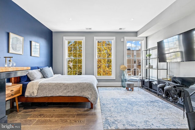 bedroom with dark hardwood / wood-style flooring