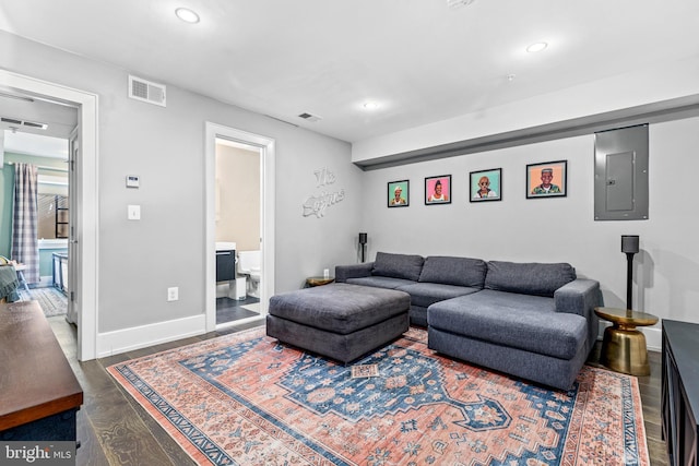 living room with dark wood-type flooring and electric panel