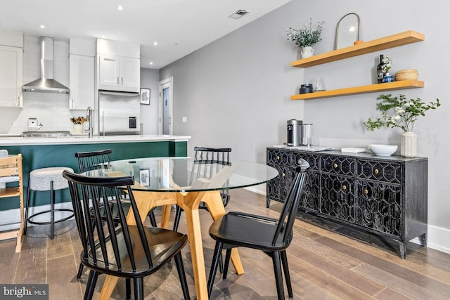 dining room with sink and hardwood / wood-style floors