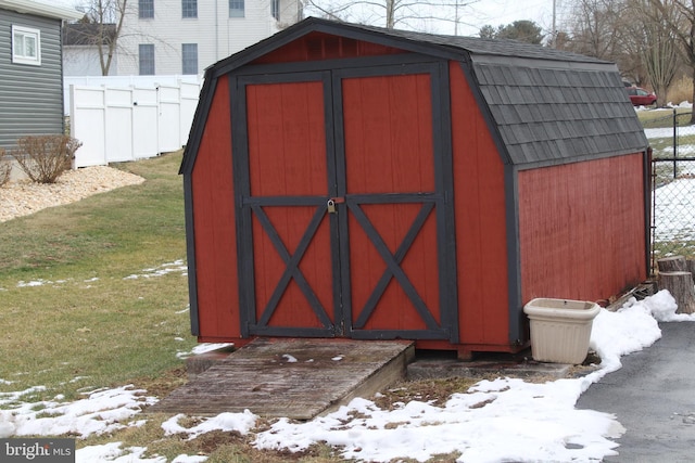 snow covered structure featuring a yard