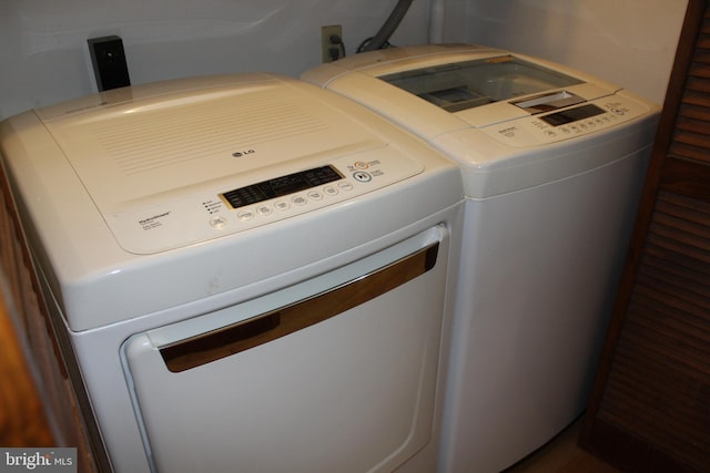 clothes washing area with washer and clothes dryer