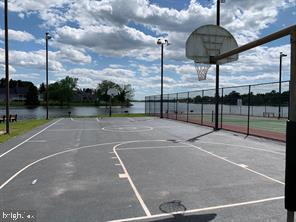 view of basketball court with a water view