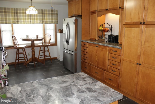 kitchen with pendant lighting and stainless steel fridge with ice dispenser