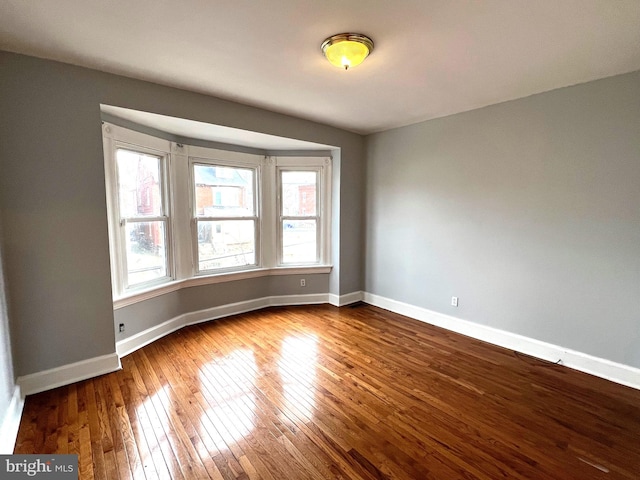 unfurnished room featuring hardwood / wood-style floors and a healthy amount of sunlight