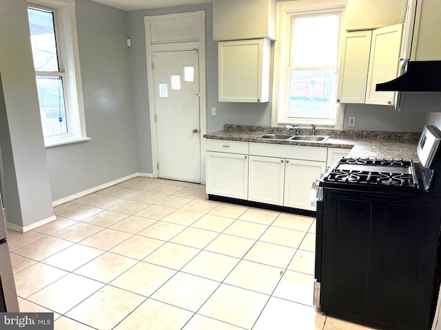 kitchen featuring range with gas stovetop, white cabinetry, sink, light tile patterned flooring, and range hood