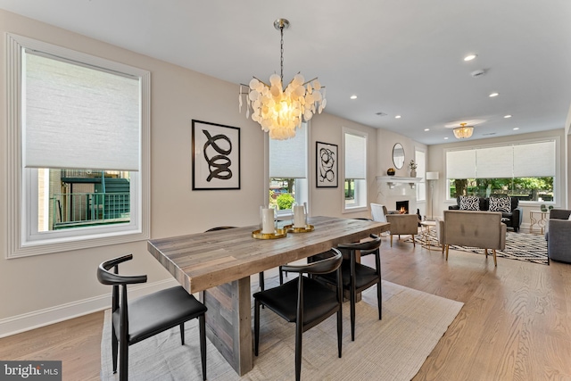 dining space with a chandelier and light wood-type flooring