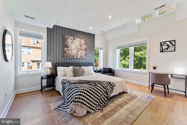 bedroom featuring lofted ceiling and light hardwood / wood-style floors