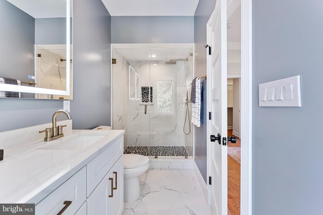 bathroom with vanity, an enclosed shower, and toilet