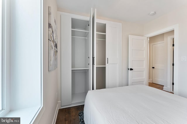 bedroom featuring dark hardwood / wood-style floors and a closet