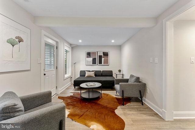 living room featuring light hardwood / wood-style floors and beamed ceiling