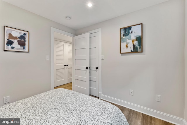 bedroom featuring wood-type flooring and a closet