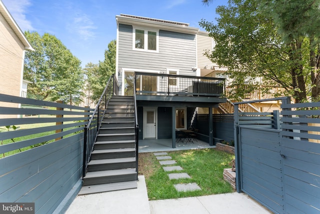 back of property featuring a patio and a deck