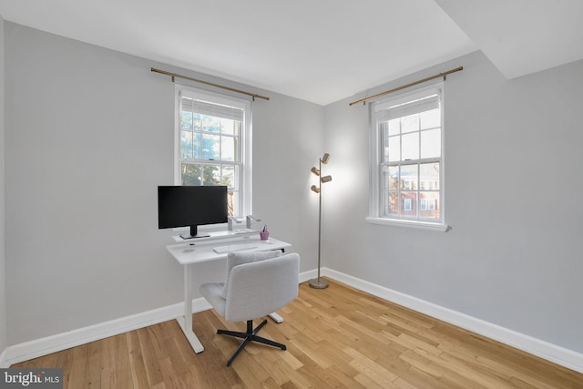 office area with light hardwood / wood-style floors