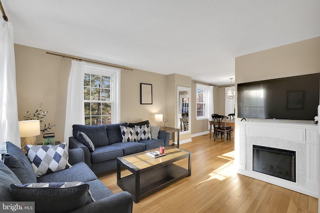 living room featuring light hardwood / wood-style floors and a textured ceiling