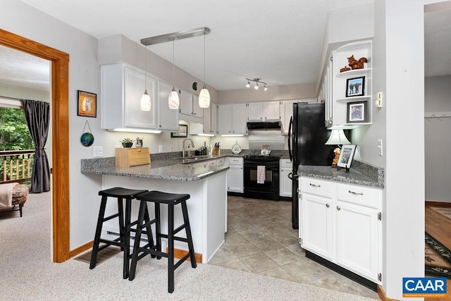 kitchen featuring pendant lighting, white cabinets, kitchen peninsula, and black appliances