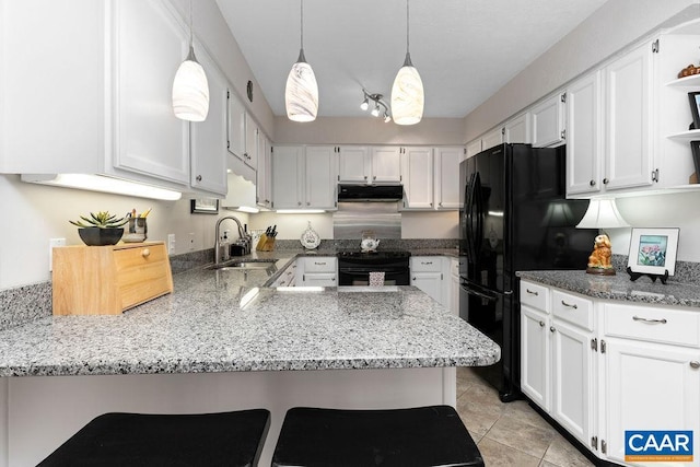 kitchen with white cabinetry, a kitchen bar, kitchen peninsula, black appliances, and sink