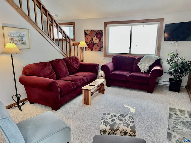 living room with baseboard heating, a wealth of natural light, and carpet flooring