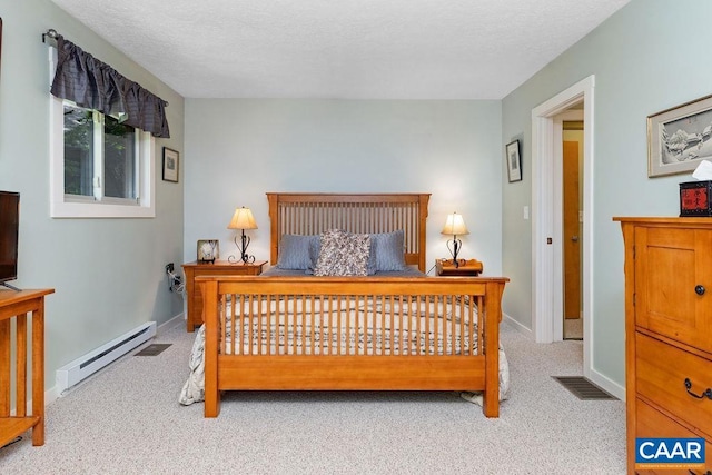 carpeted bedroom with a baseboard heating unit