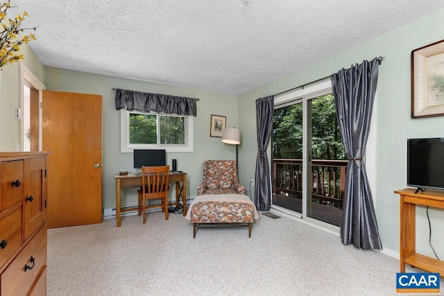 sitting room featuring a baseboard heating unit and a textured ceiling