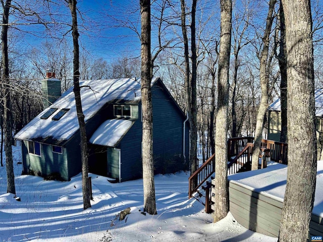 snow covered property featuring a deck