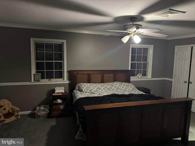 carpeted bedroom featuring ceiling fan and crown molding