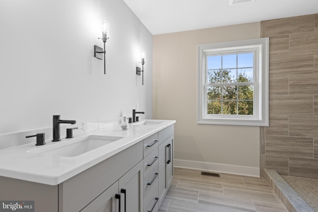 bathroom with walk in shower and vanity