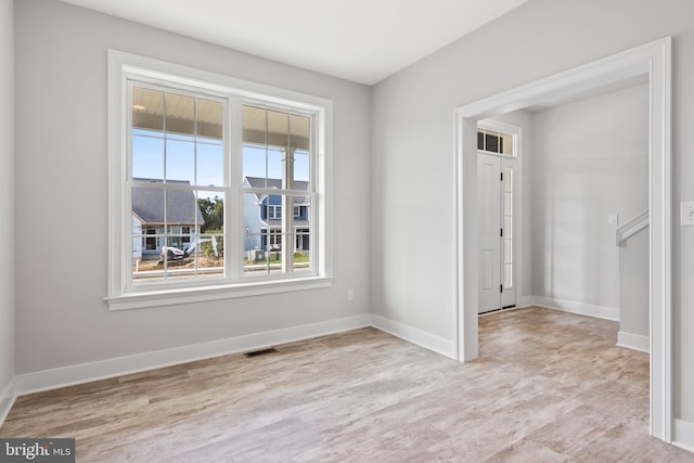 unfurnished room with light hardwood / wood-style floors