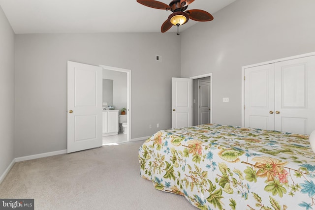 bedroom with visible vents, baseboards, carpet flooring, ensuite bathroom, and a closet