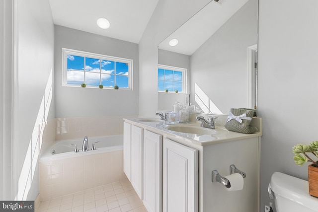 bathroom featuring a sink, a garden tub, toilet, and tile patterned flooring