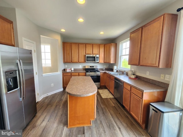 kitchen featuring recessed lighting, stainless steel appliances, dark wood-type flooring, and a center island