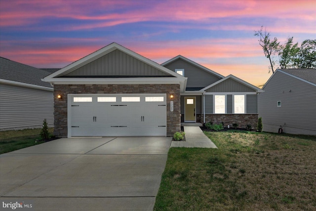 view of front of home with a garage and a lawn