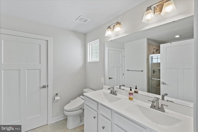 bathroom featuring toilet, tile patterned floors, an enclosed shower, and vanity