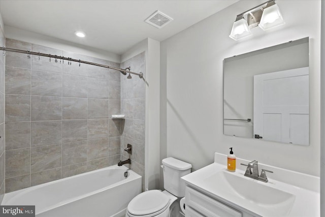 full bathroom with toilet, tiled shower / bath combo, and vanity