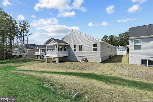 rear view of house featuring a yard