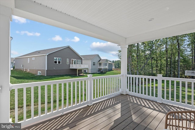 wooden terrace with a lawn