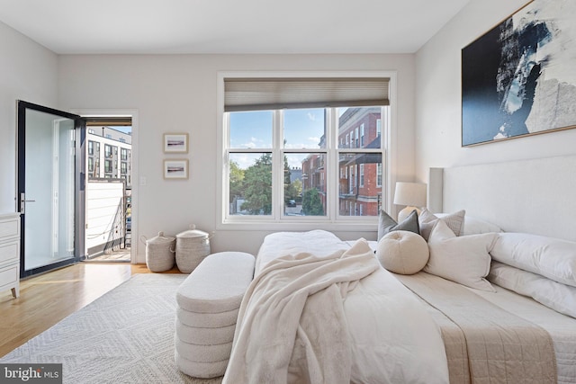 bedroom featuring access to exterior and light hardwood / wood-style flooring