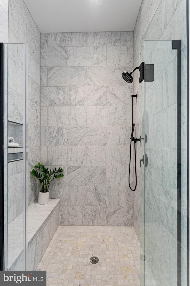 bathroom featuring a shower with door