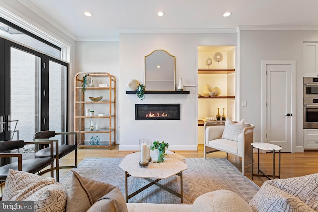 living room featuring french doors, light hardwood / wood-style flooring, and ornamental molding