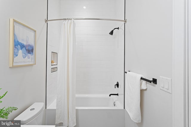 bathroom with toilet and shower / bath combo