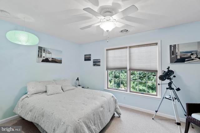 bedroom with ceiling fan and light colored carpet