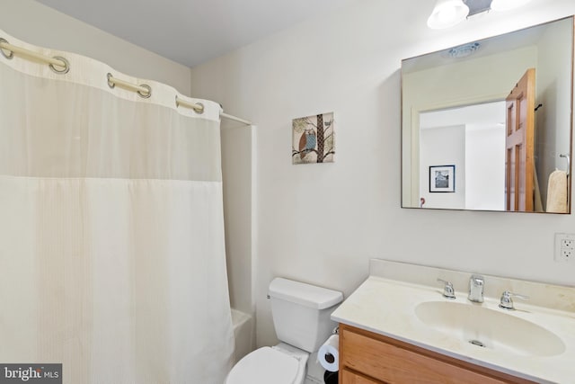 full bathroom with toilet, vanity, and shower / bath combo with shower curtain