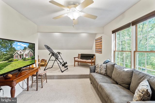 living room with ceiling fan, light colored carpet, and vaulted ceiling