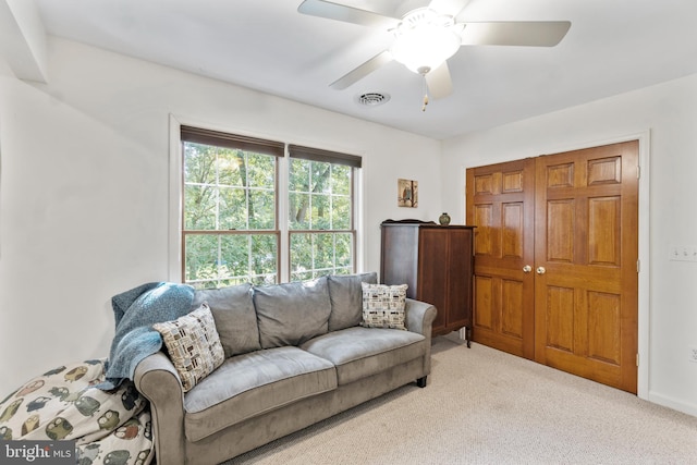 living room featuring ceiling fan and light carpet