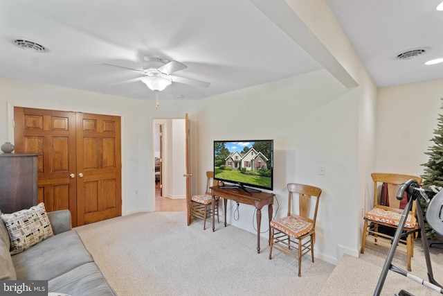 living room with ceiling fan and light colored carpet