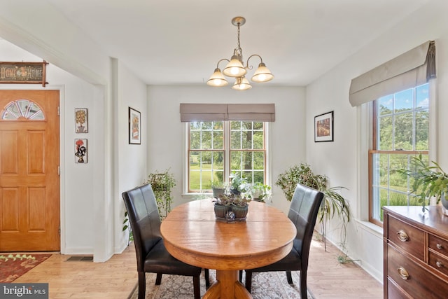 dining room featuring an inviting chandelier and light hardwood / wood-style floors