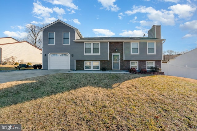 bi-level home with a garage and a front yard