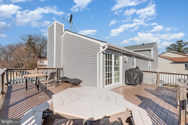 wooden deck with a grill