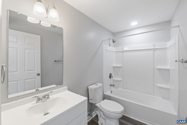 full bathroom with toilet, vanity, wood-type flooring, and shower / washtub combination